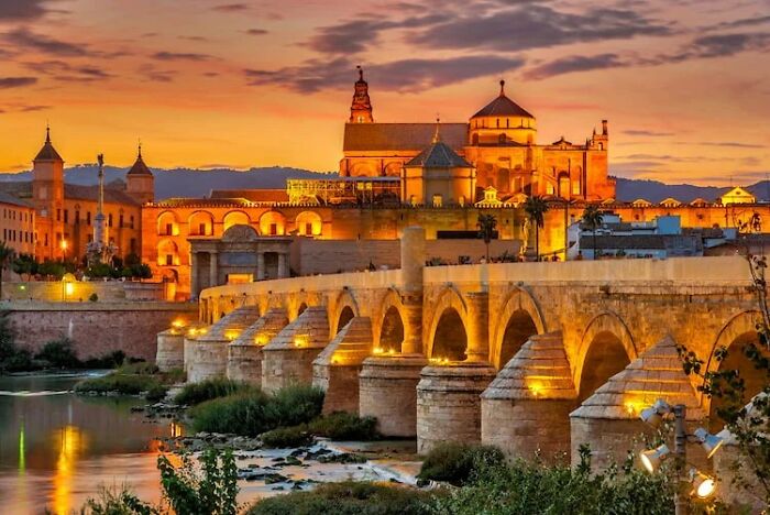 The Cordoba Roman Bridge Stands As A Testament To The City's Rich History And Architectural Heritage. It Offers A Picturesque View Of The Guadalquivir River And Serves As A Pedestrian Walkway, Allowing Visitors To Cross From One Side Of The River To The Other While Enjoying The Scenic Surroundings