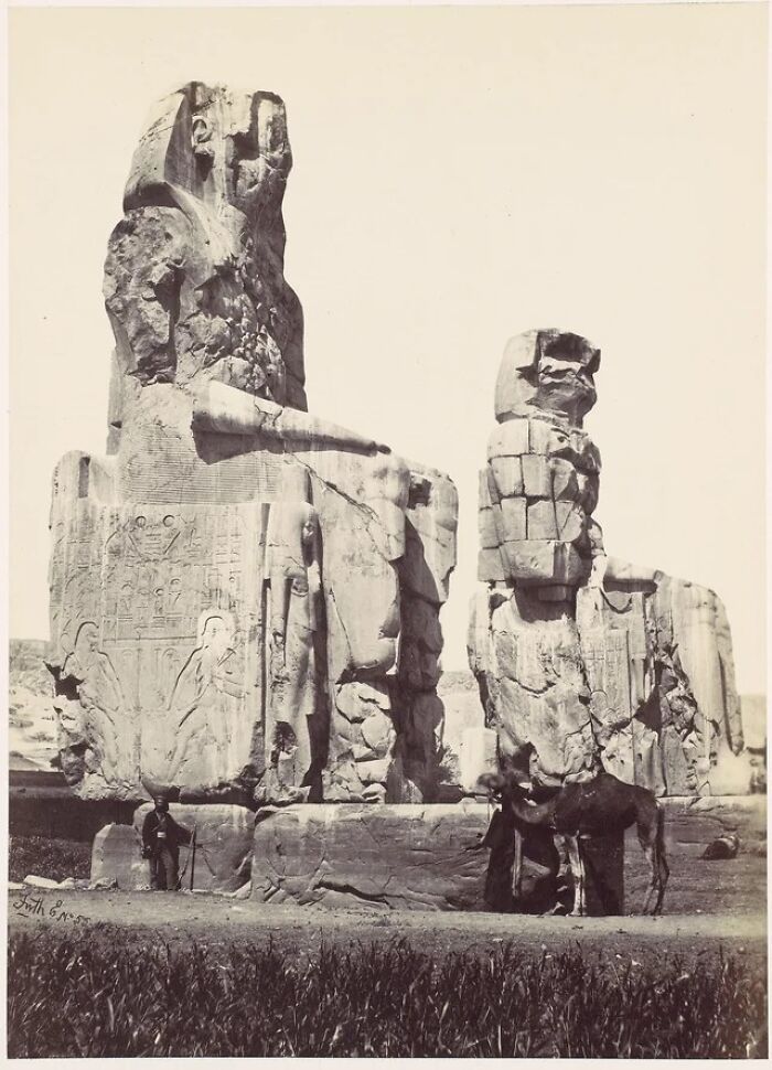 The Colossi Of Memnon, Two Huge Statues Of Egyptian Pharaoh Amenhotep III That Stand Where His Mortuary Temple Was Once Located, As They Appeared In 1857