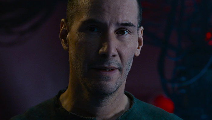 Keanu Reeves wearing green shirt