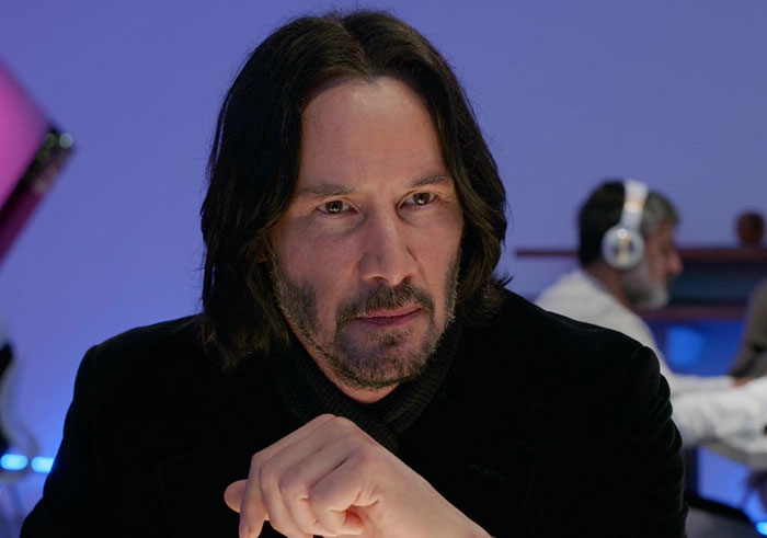 Keanu Reeves wearing black sweater