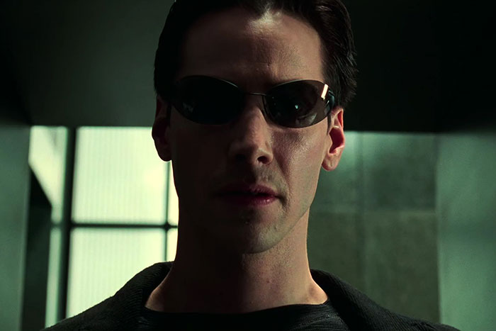 Keanu Reeves wearing glasses