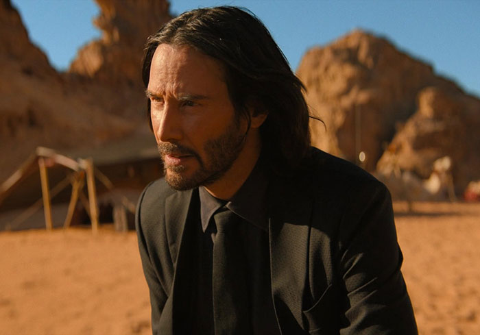 Keanu Reeves wearing black suit