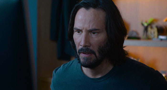 Keanu Reeves wearing blue shirt