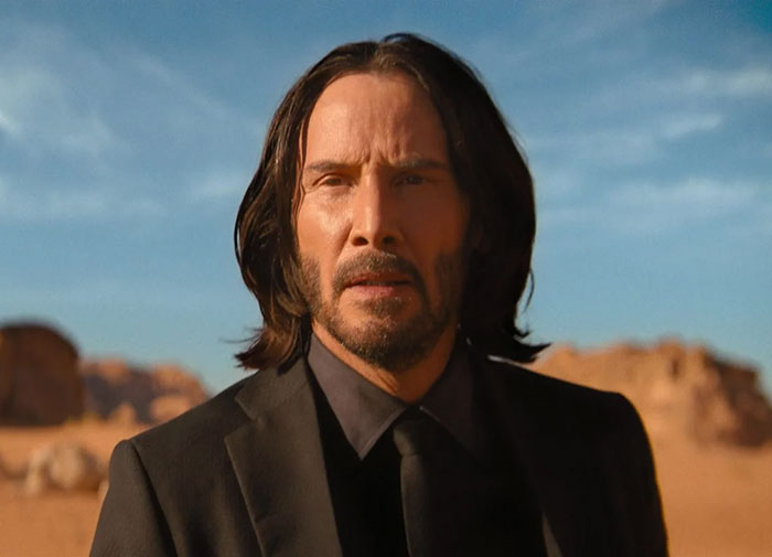 Keanu Reeves wearing black suit