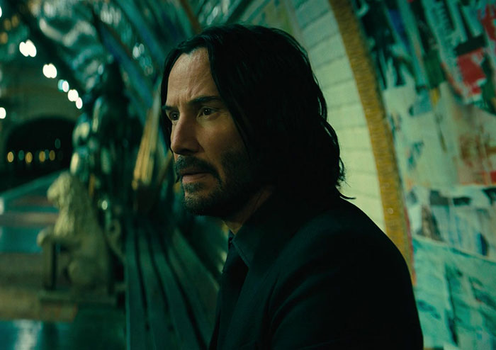 Keanu Reeves wearing black suit