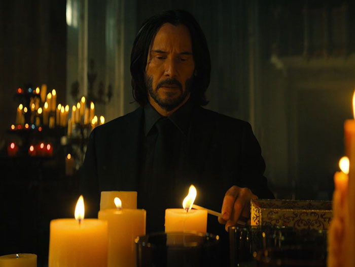 Keanu Reeves wearing black suit