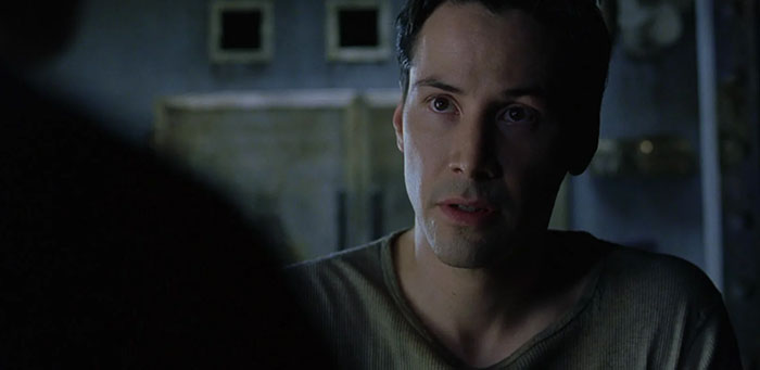 Keanu Reeves wearing brown shirt