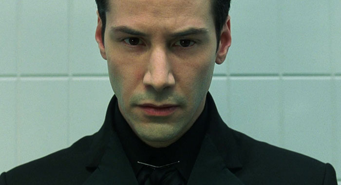 Keanu Reeves wearing black coat