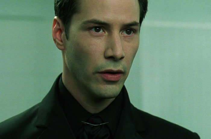 Keanu Reeves wearing black suit