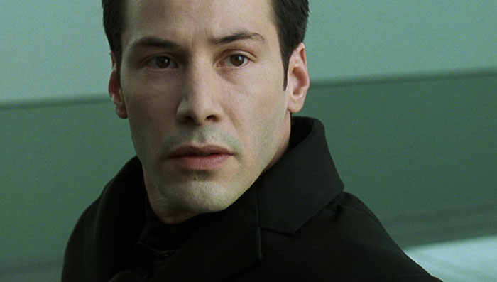Keanu Reeves wearing black coat