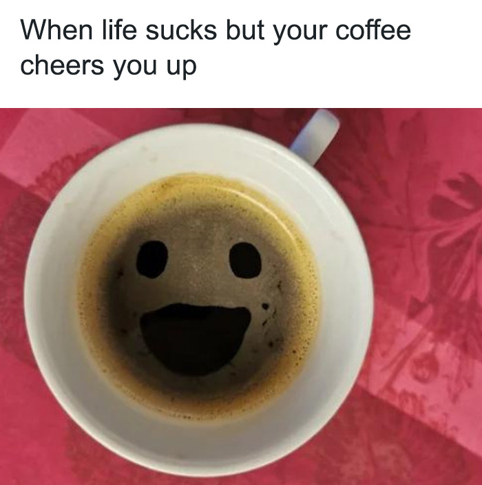 A coffee meme featuring a top-down view of a coffee cup with the foam forming a smiley face. The text above the image reads, "When life s***s but your coffee cheers you up." The meme humorously highlights the comforting and mood-lifting effect of a good cup of coffee, even when things aren't going well.