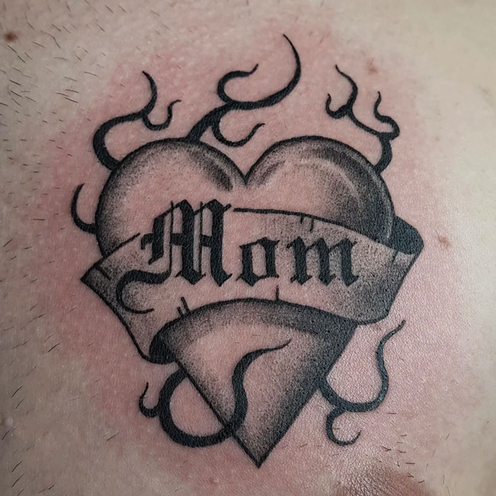 Heart with the word 'mom' in it memorial tattoo
