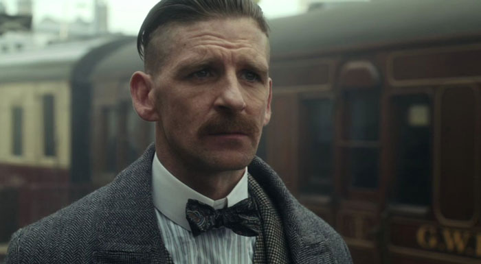 Arthur Shelby looking sad in a train station