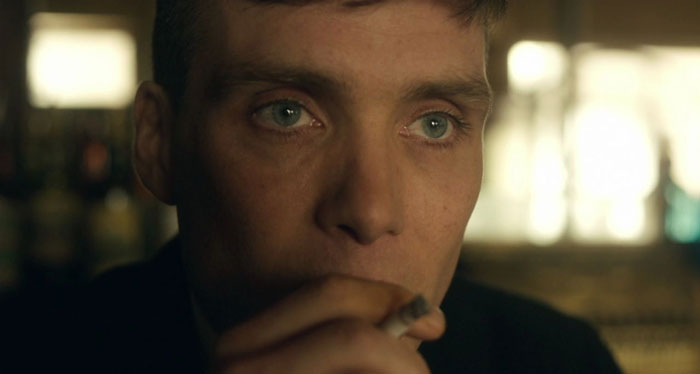 Tommy Shelby smoking a cigarette in a close up shot