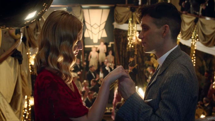 Grace Burgess and Tommy Shelby looking at each other and holding hands
