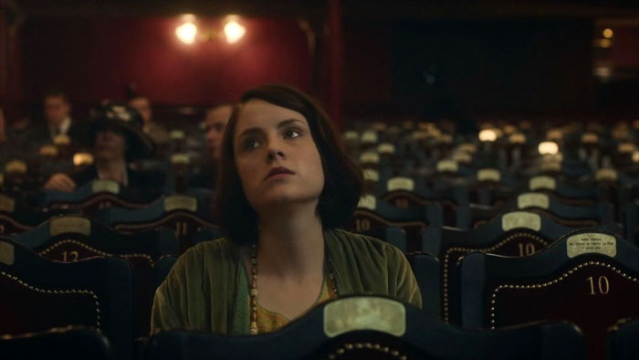 Ada Shelby sitting in a movie theater looking annoyed