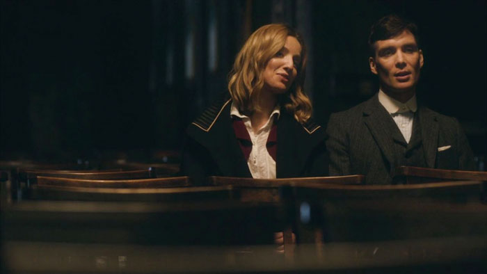 Grace Burgess and Tommy Shelby sitting in a church