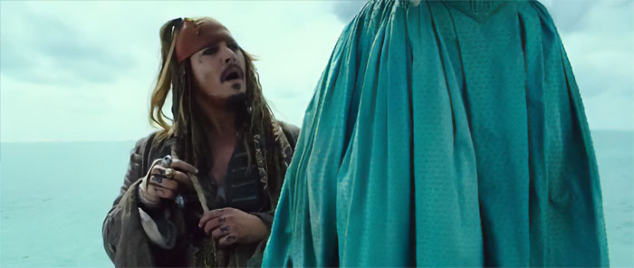 Jack Sparrow looking at a tall person 