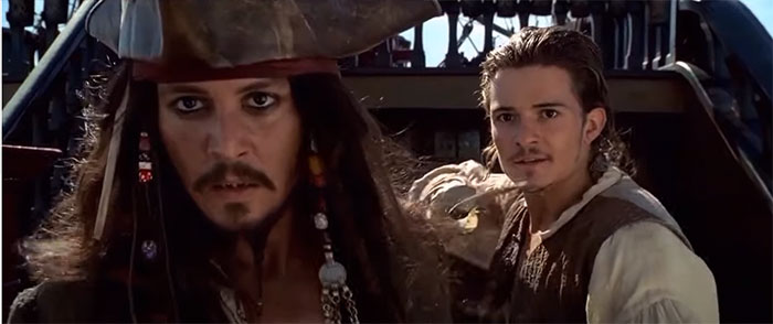 Jack Sparrow looking forward while there is a sword at his back 