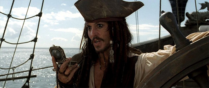 Jack Sparrow looking at clock while standing on ship 