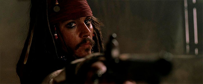 Jack Sparrow pointing a gun