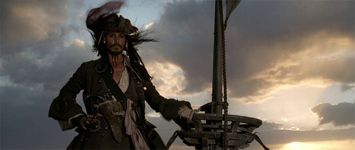 Jack Sparrow standing on top of the ship 