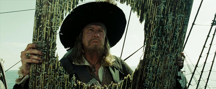 Captain Barbossa looking at a hole