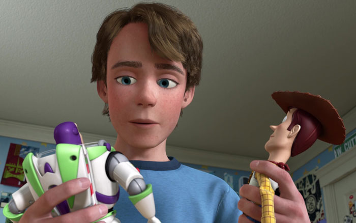 Andy holding Woody and Buzz Lightyear