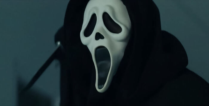 Ghostface holding a metal object 