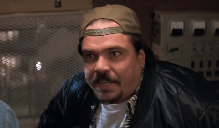 Kenny wearing a hat and talking to someone 