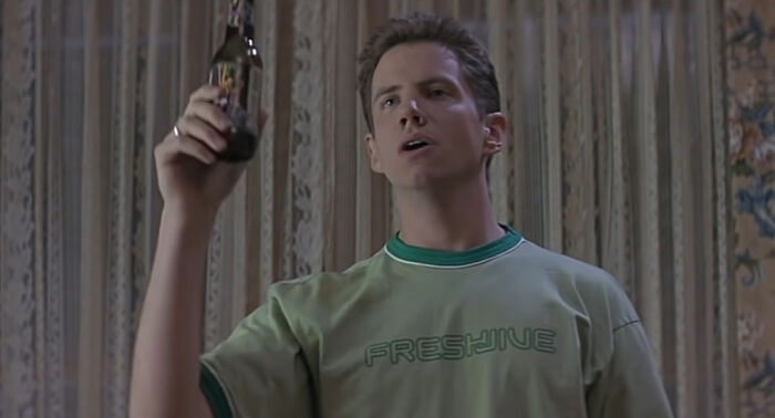 Randy Talking while holding a glass bottle 