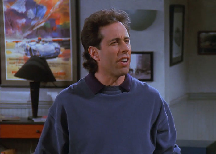 Jerry wearing a blue shirt delivering one of the funniest Seinfeld quotes that sum up everyday life in a sitcom setting