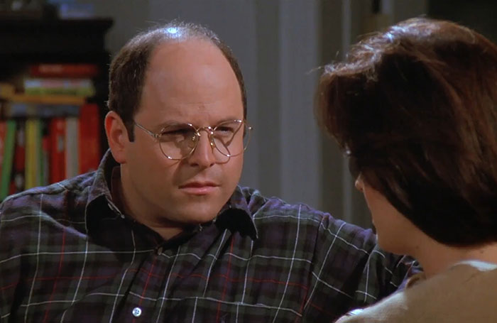 George from Seinfeld wearing a plaid shirt, captured in a scene reflecting funniest Seinfeld quotes about everyday life.