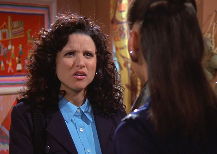 Elaine wearing black jacket and blue shirt