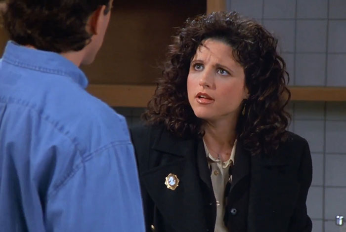 Elaine in a black jacket and yellow shirt expressing surprise, capturing funniest Seinfeld quotes from everyday life moments