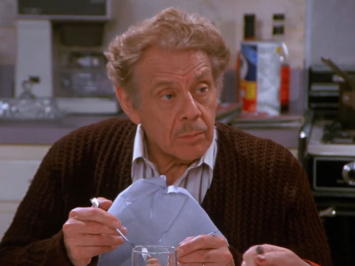 Frank Costanza from Seinfeld wearing a brown sweater, depicting one of the funniest Seinfeld quotes about everyday life.