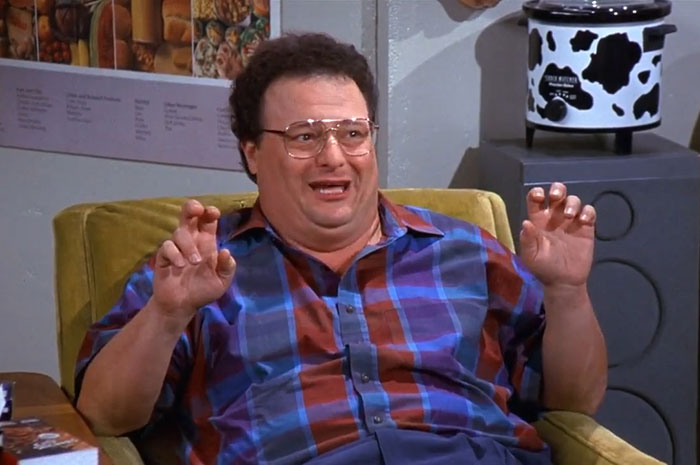 Newman from Seinfeld wearing a blue and red shirt, illustrating one of the funniest Seinfeld quotes about everyday life.