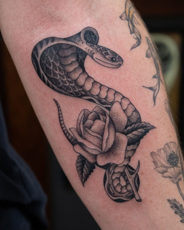 snake and rose tattoo on the hand