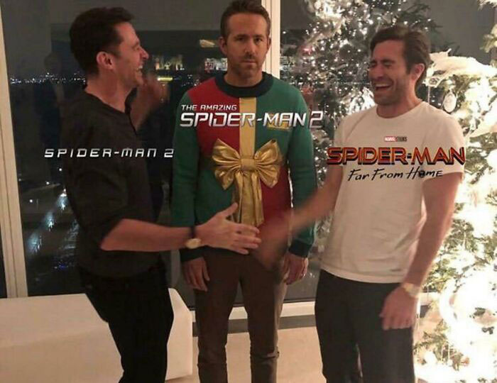 Three men laughing near a Christmas tree, with each labeled as various Spider-Man films.