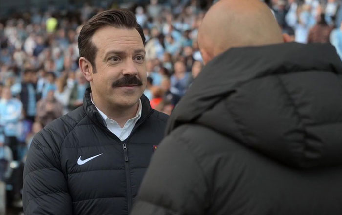 Ted Lasso wearing white shirt and jacket