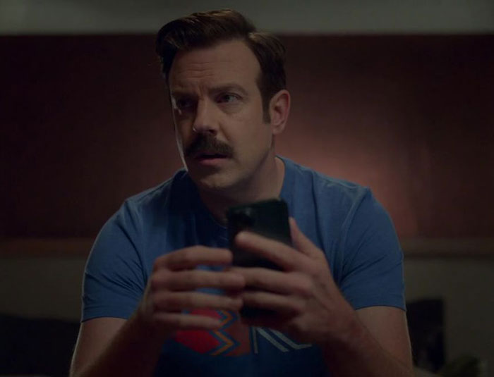 Ted Lasso wearing blue shirt