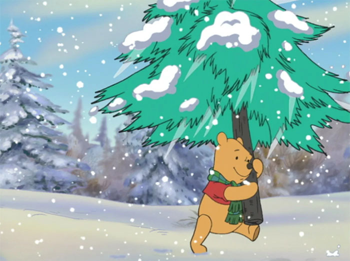 Winnie the Pooh carrying a fir tree