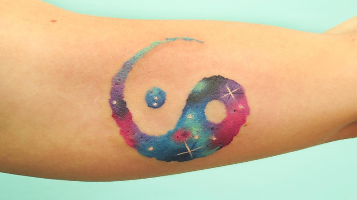 Colourful yin yang symbol tattoo 