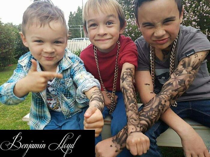 Kids with spray-on tattoos smile outdoors, showcasing temporary art to brighten their day.