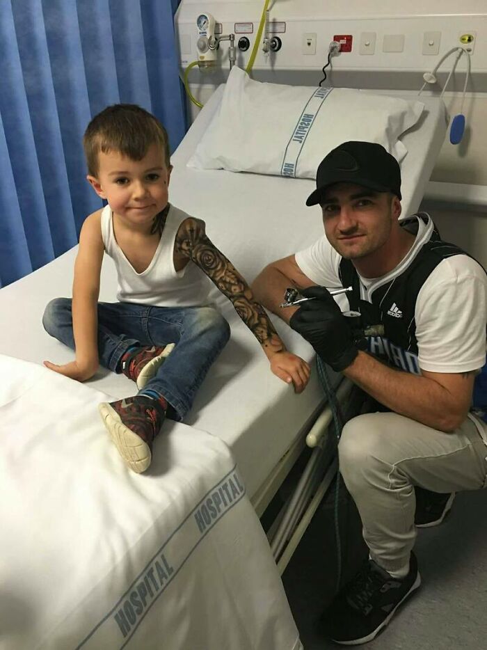 Artist giving hospitalized kid a spray-on tattoo in a cheerful hospital setting.