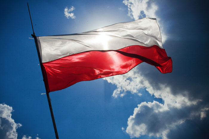 Polish flag waving against a cloudy sky, representing a woman speaking to their kid in Polish despite boyfriend’s request. Polish flag waving against a cloudy sky, representing a woman speaking to their kid in Polish despite boyfriend’s request.