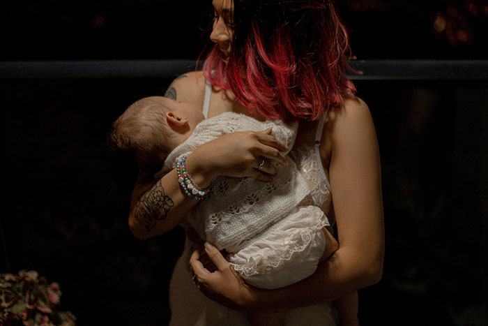 Woman holding baby while speaking in Polish, highlighting a family language dynamic and parenting challenge. Woman holding baby while speaking in Polish, highlighting a family language dynamic and parenting challenge.
