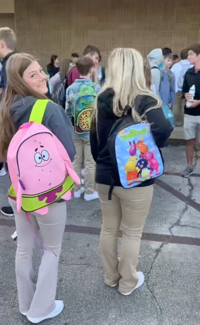 High school seniors wearing colorful kindergarten backpacks at school. High school seniors wearing colorful kindergarten backpacks at school.