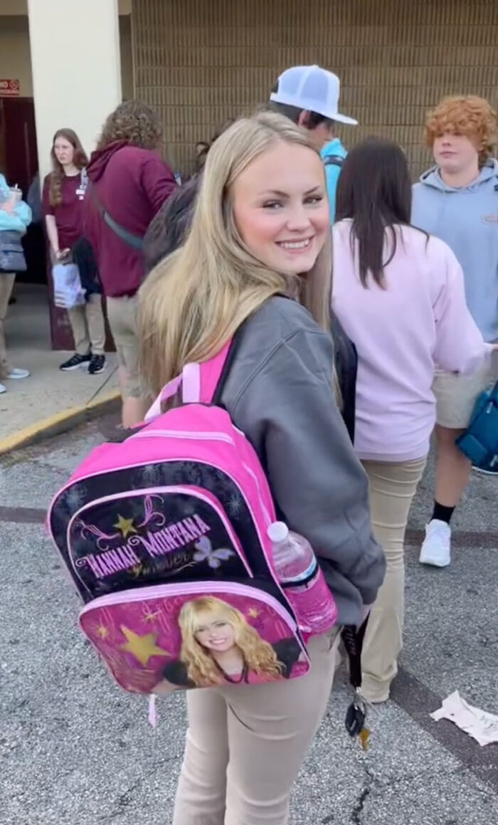 High school senior with a bright pink Hannah Montana kindergarten backpack at school. High school senior with a bright pink Hannah Montana kindergarten backpack at school.