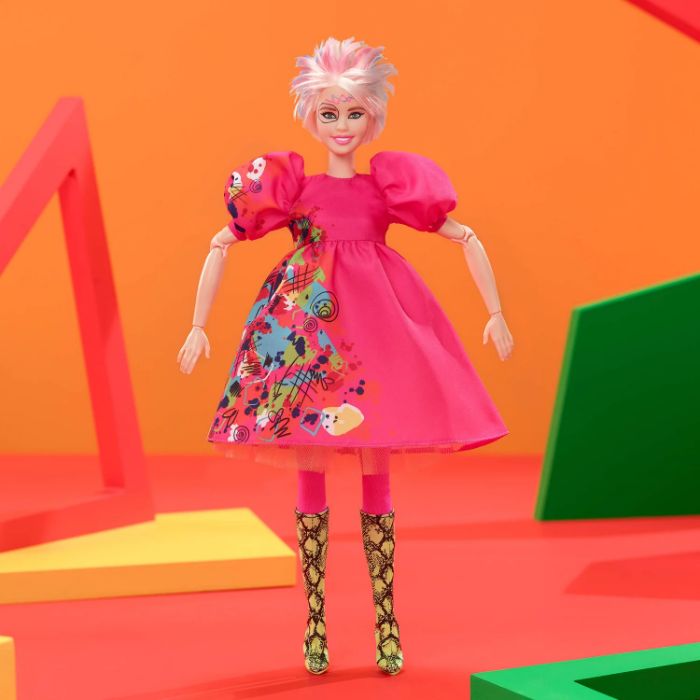 Weird Barbie in a vibrant pink dress with colorful patterns and unique hairstyle, posed against an orange backdrop. Weird Barbie in a vibrant pink dress with colorful patterns and unique hairstyle, posed against an orange backdrop.